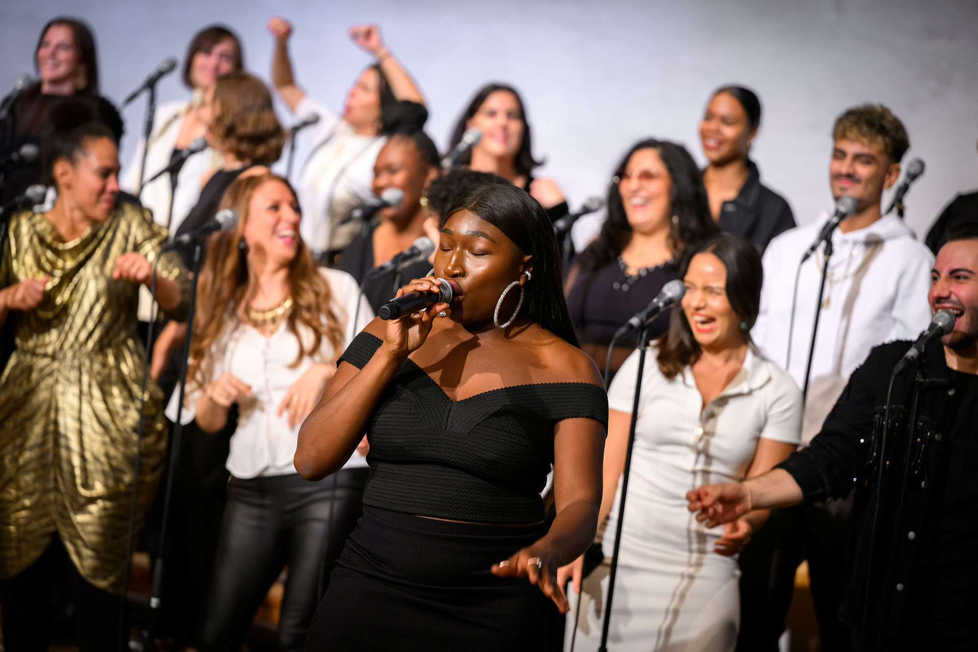 En gospelkör med en kvinnlig lead-singer sjunger och dansar.
