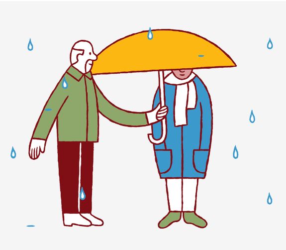 En man håller upp ett parably åt en kvinna när det regnar.