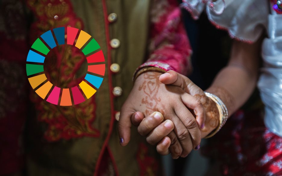 Två personer med hennatatueringar håller varandra i handen. Till vänster syns loggan för Agenda 2030.