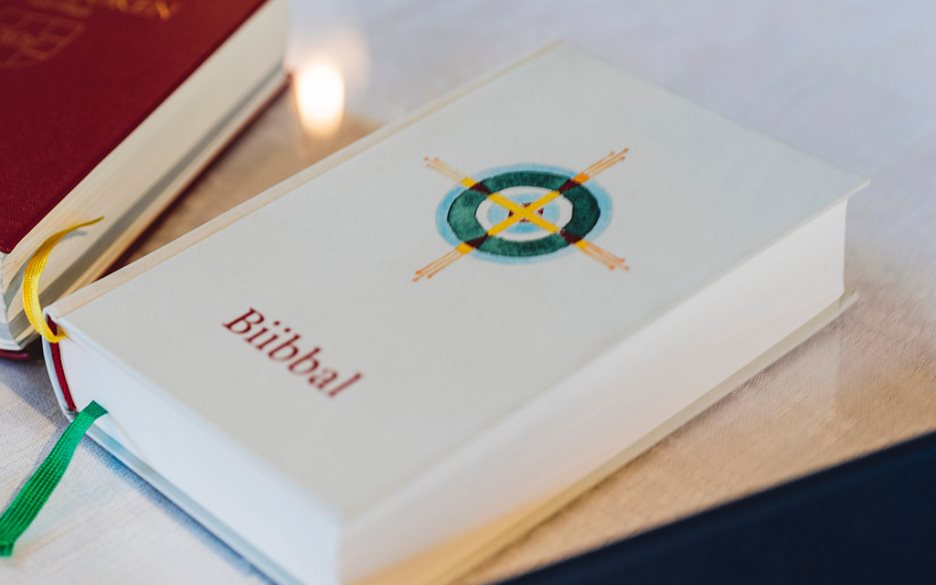En vit samisk bibel på bordet.