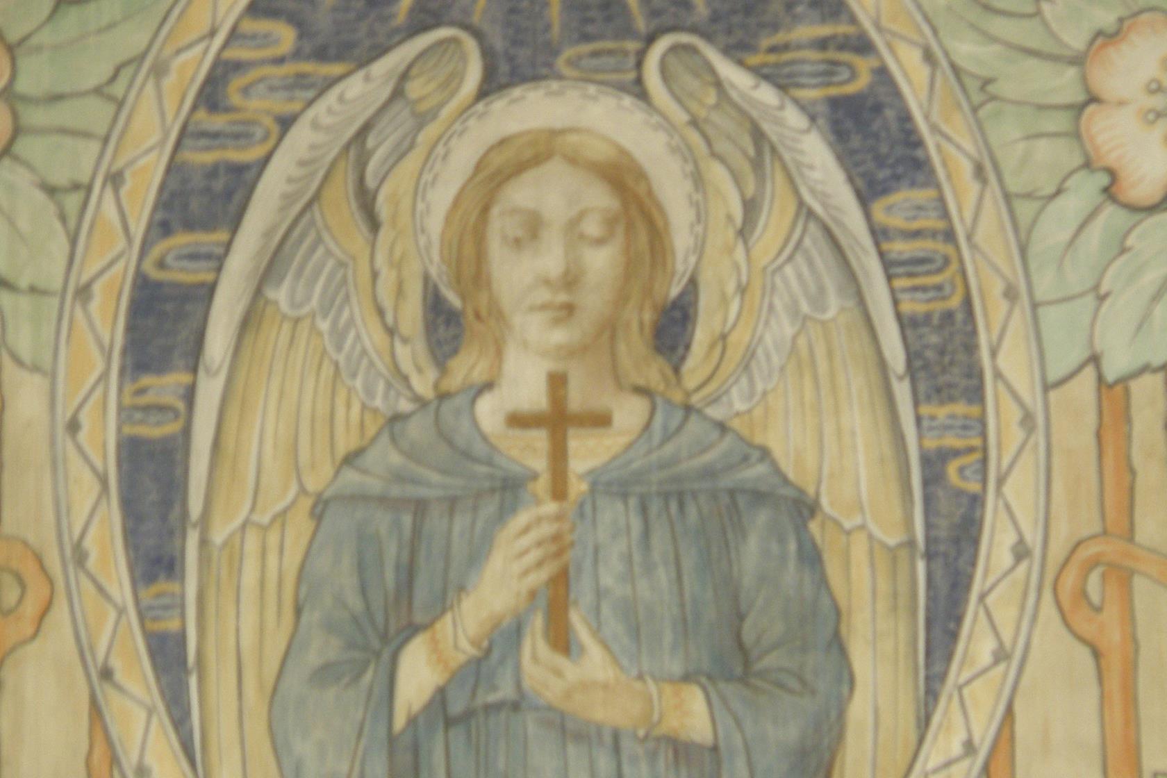 Väggmålning av ängel med kors i handen.