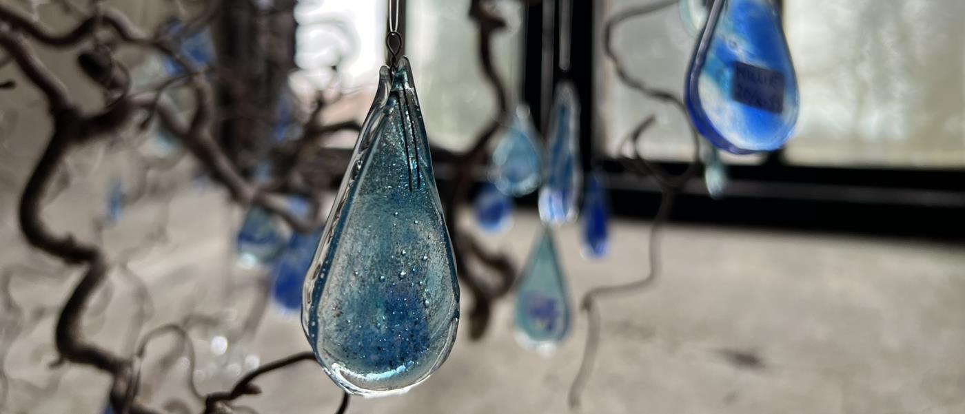 dopdroppar av genomskinligt glas med blåa inslag