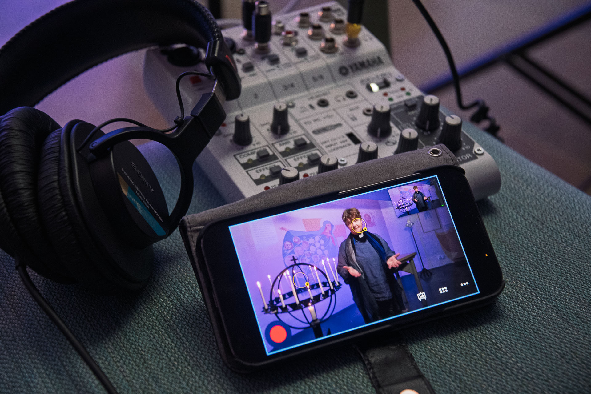 Nätprästen Charlotte syns genom en mobilskärm.