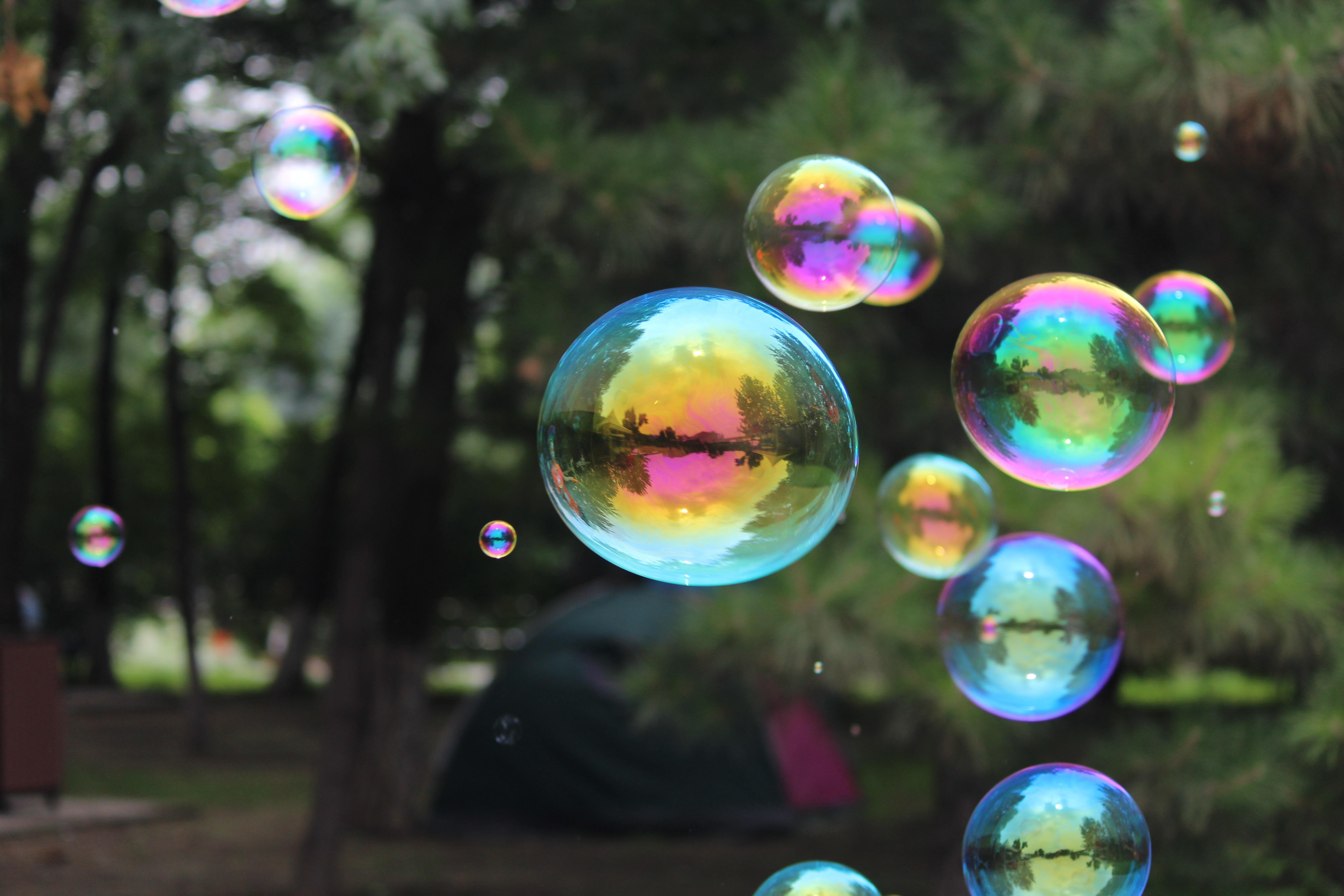Stora såpbubblor som skimrar i regnbågens färger.