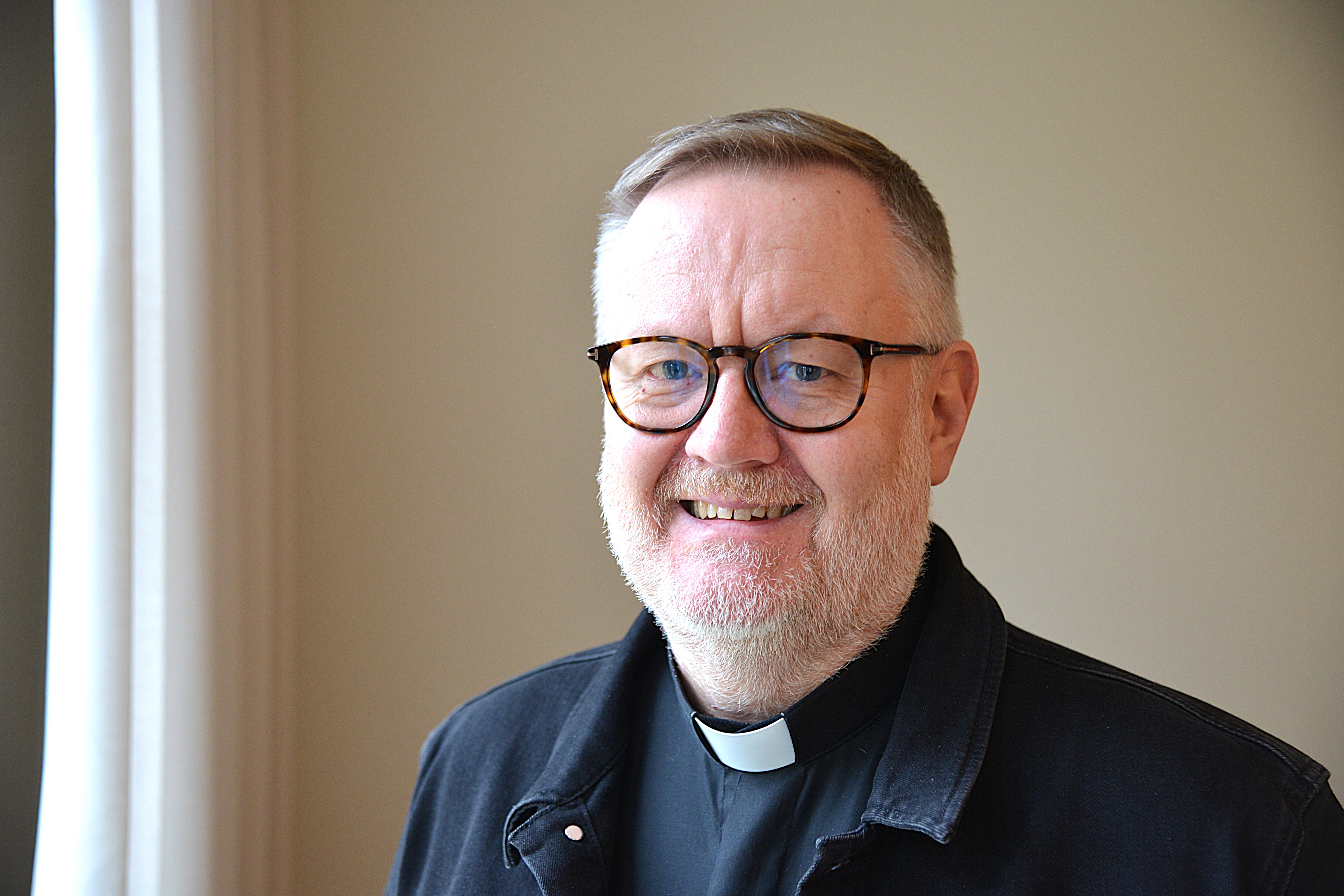 Porträtt av en man med glasögon och prästkrage