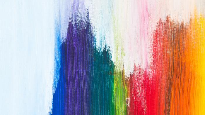 Abstrakt bild på regnbågsfärgade penseldrag.