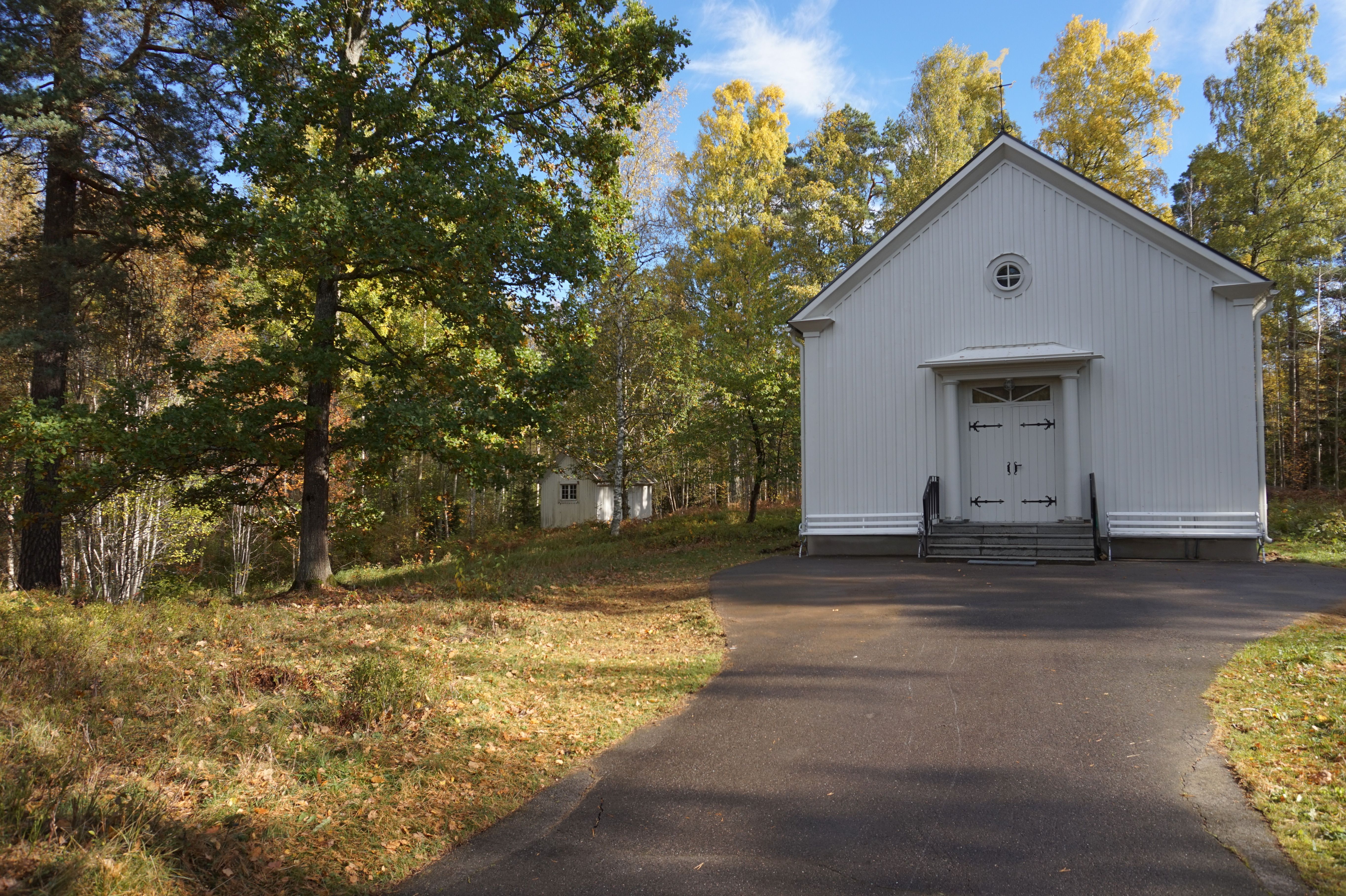 Mariedamms kapell en vårdag med skogsbrynet i bakgrunden.