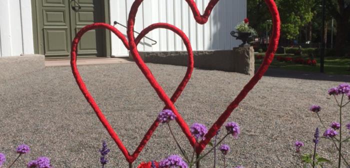 Röda hjärtan i rabatten vid Högbo kyrka.