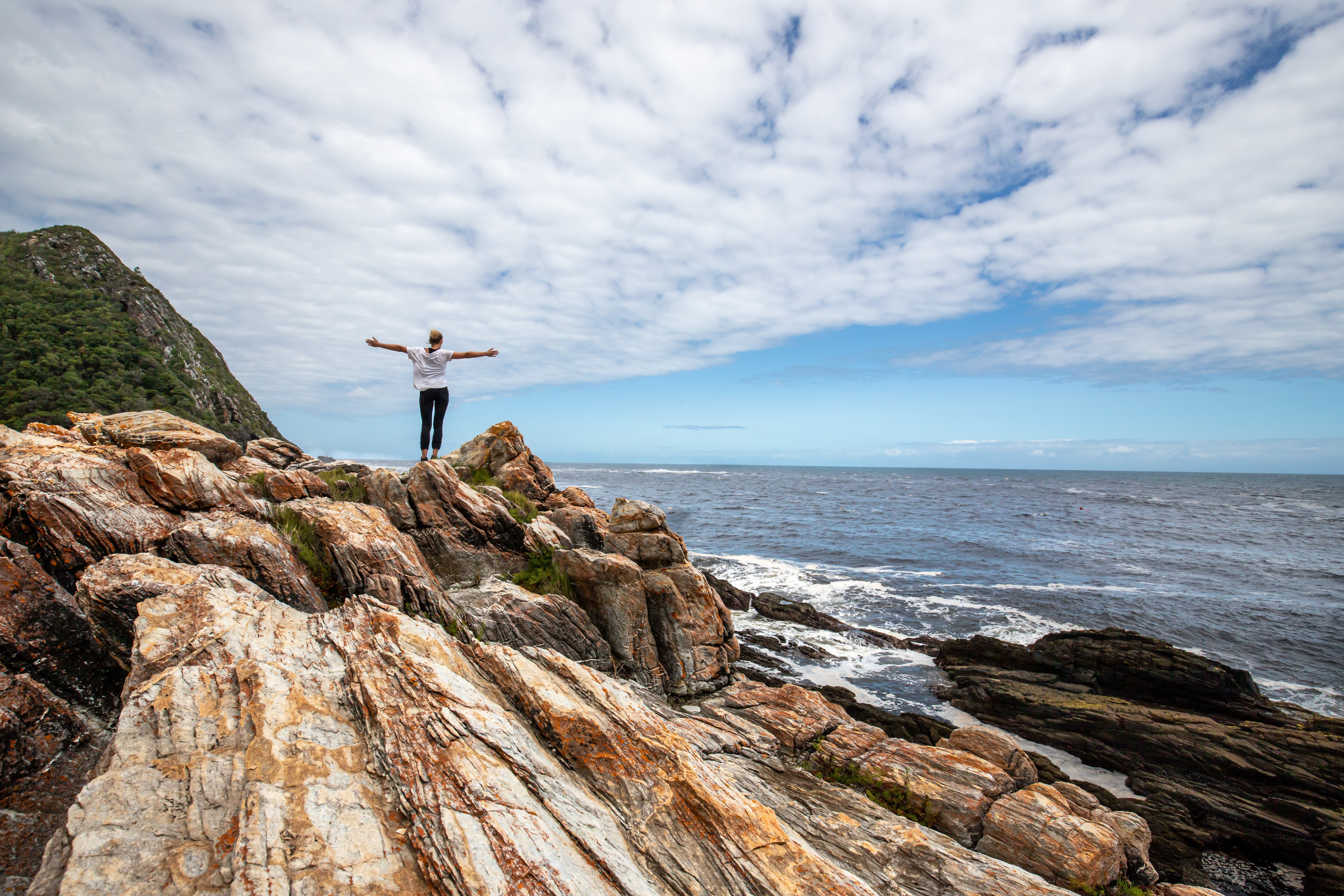 Person an Felsenstrand