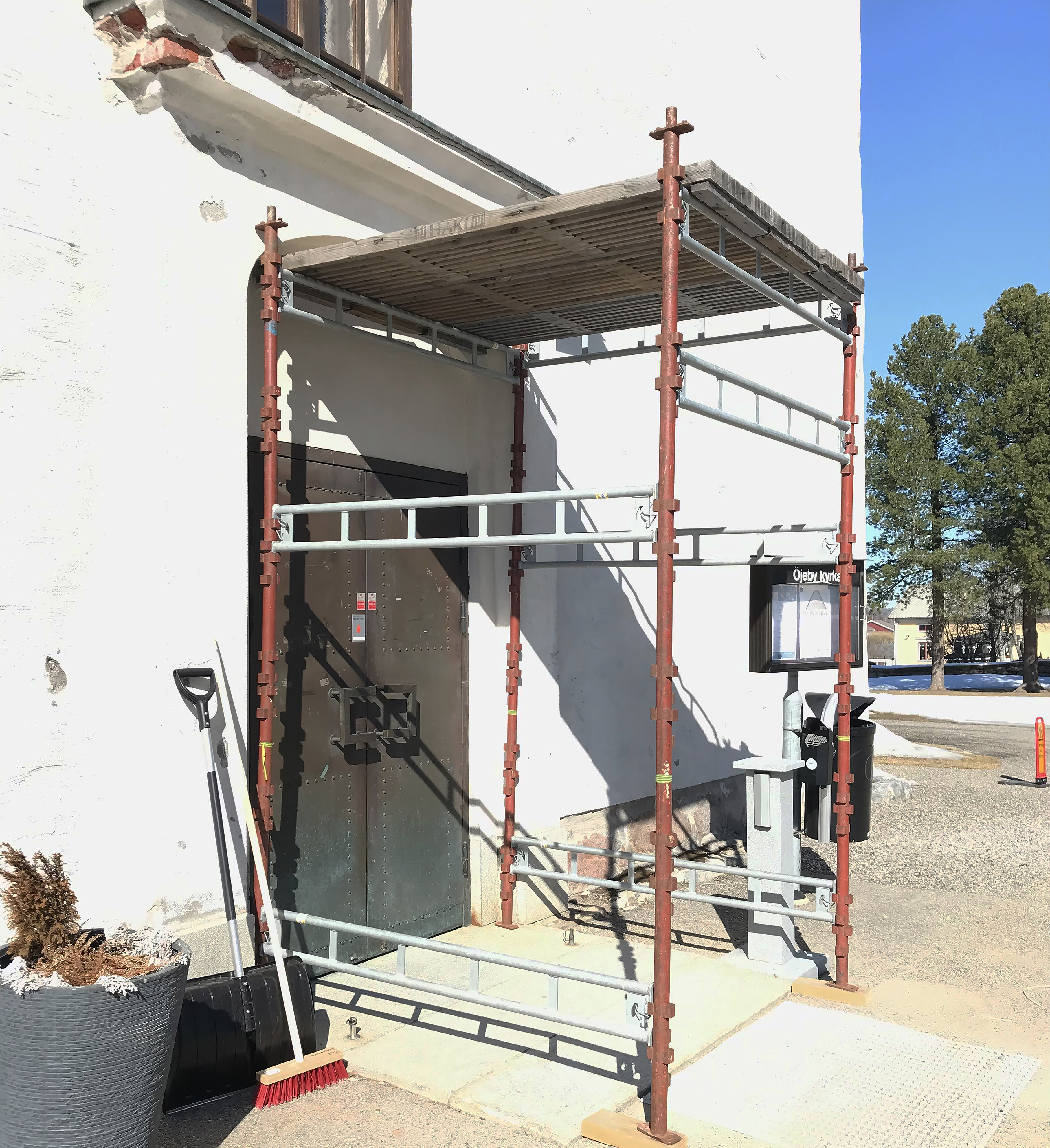 Byggställning utanför Öjeby kyrkas entré. 