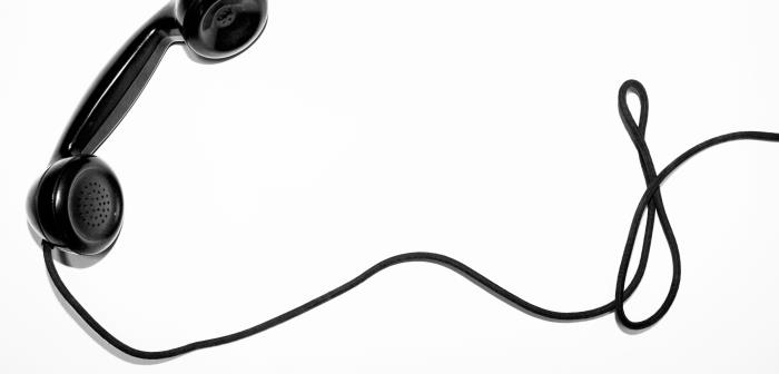 En svart gammaldags telefonlur med lång sladd.