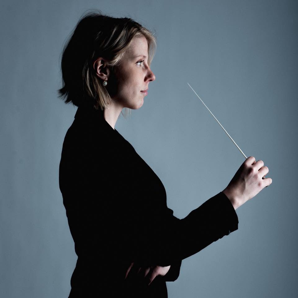 Sofia Ågren i profil. Hon håller en dirigentpinne.