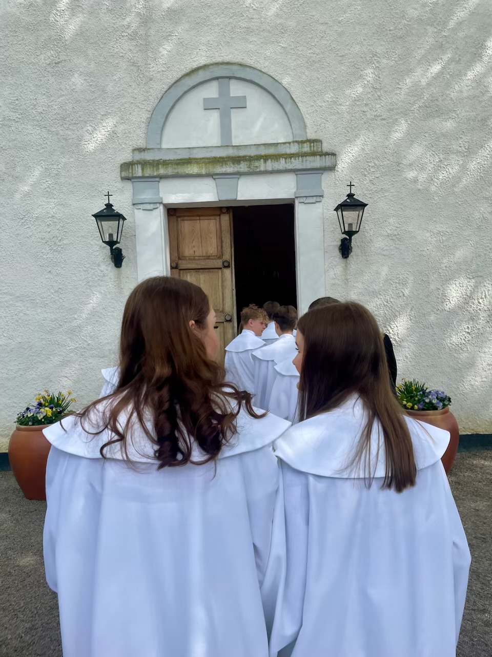 Konfirmander går in i kyrkan.