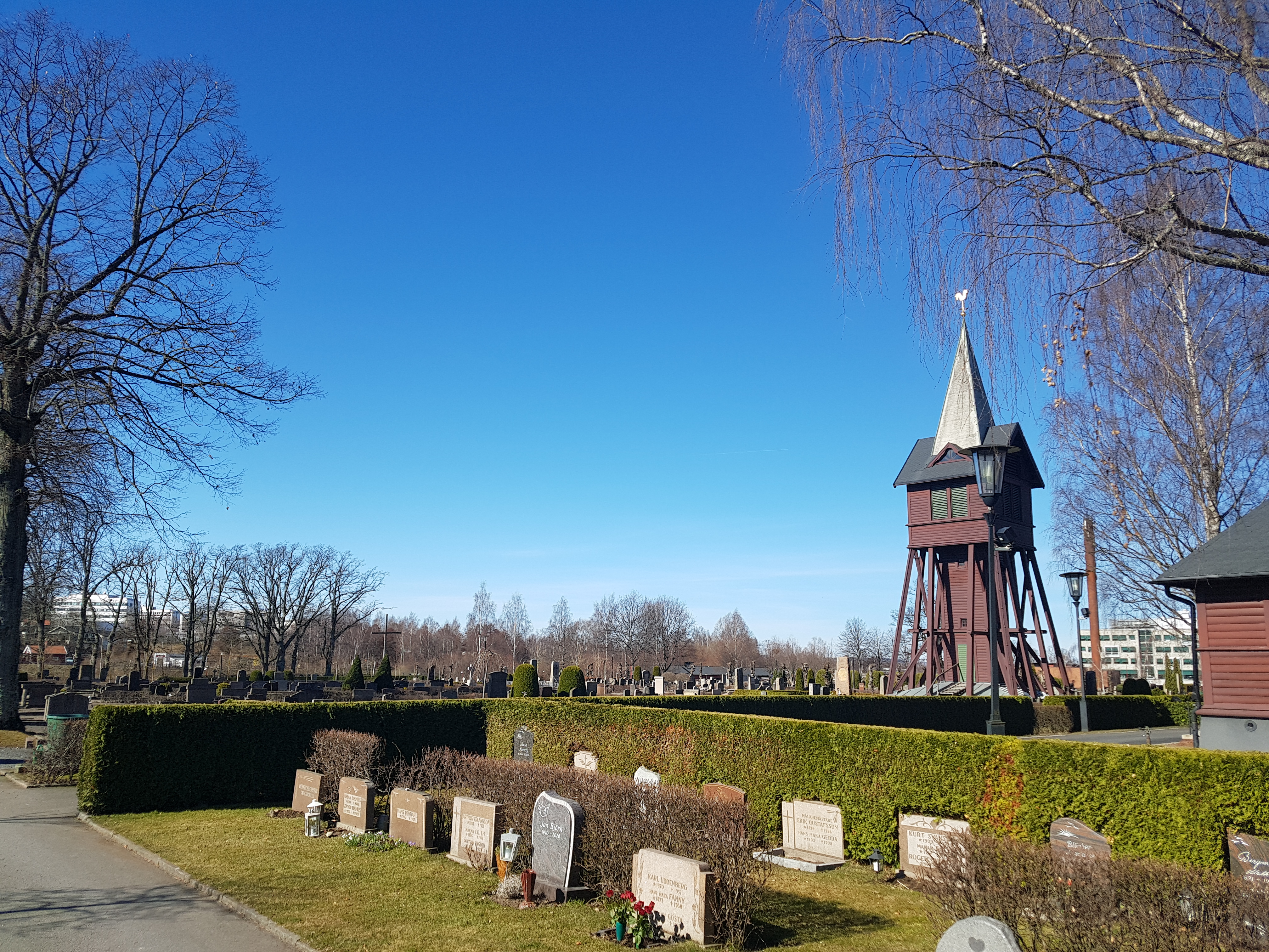 Bild på Huskvarna kyrkogård med klockstapeln i blickfånget