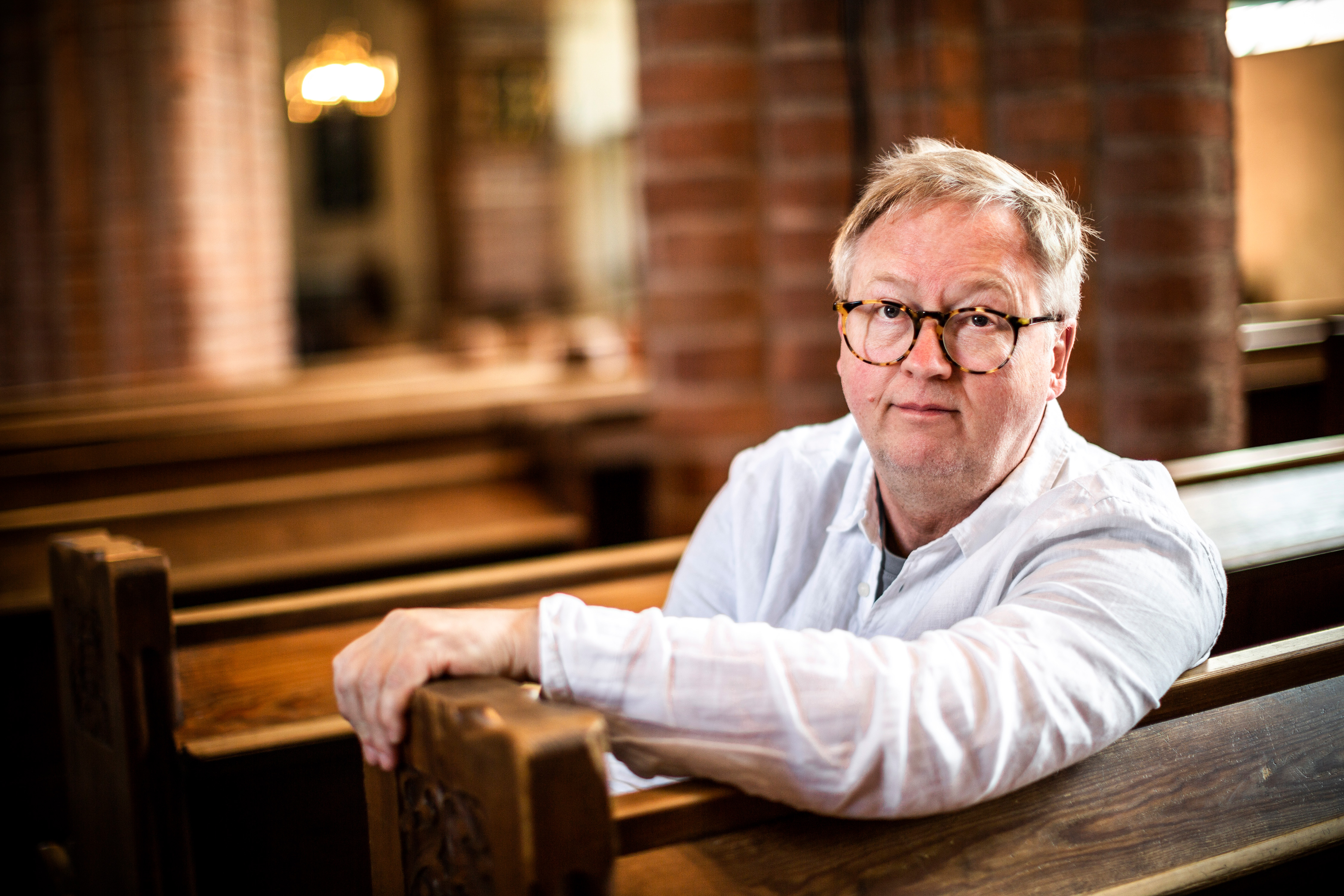 Mats Hermansson sitter på en kyrkbänk