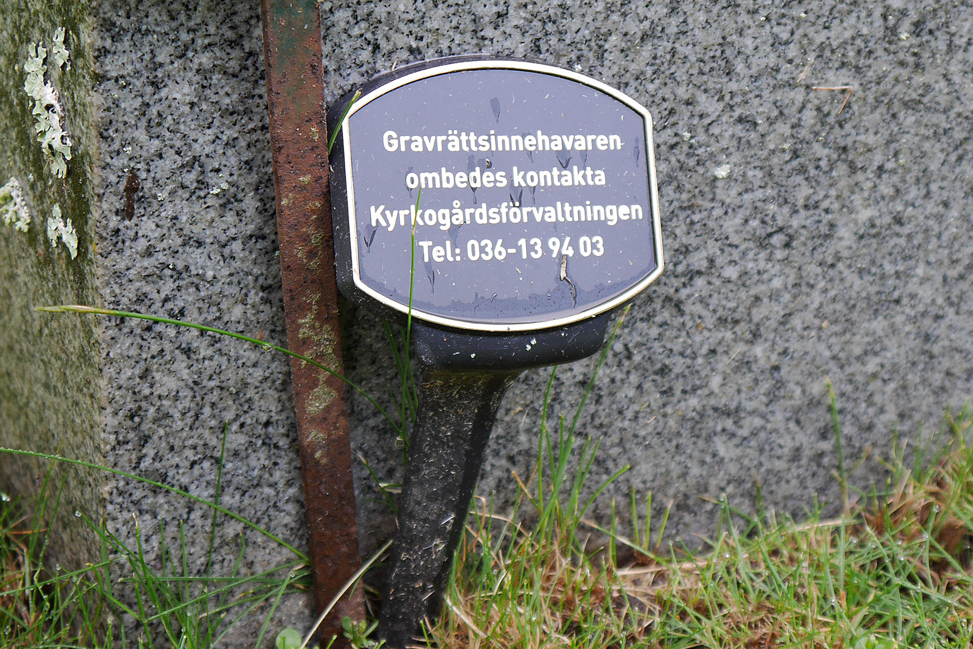 Skylt vid gravsten, kontakta kyrkogårdsförvaltningen