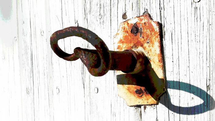 En rostig gammal nyckel i en gammal dörr