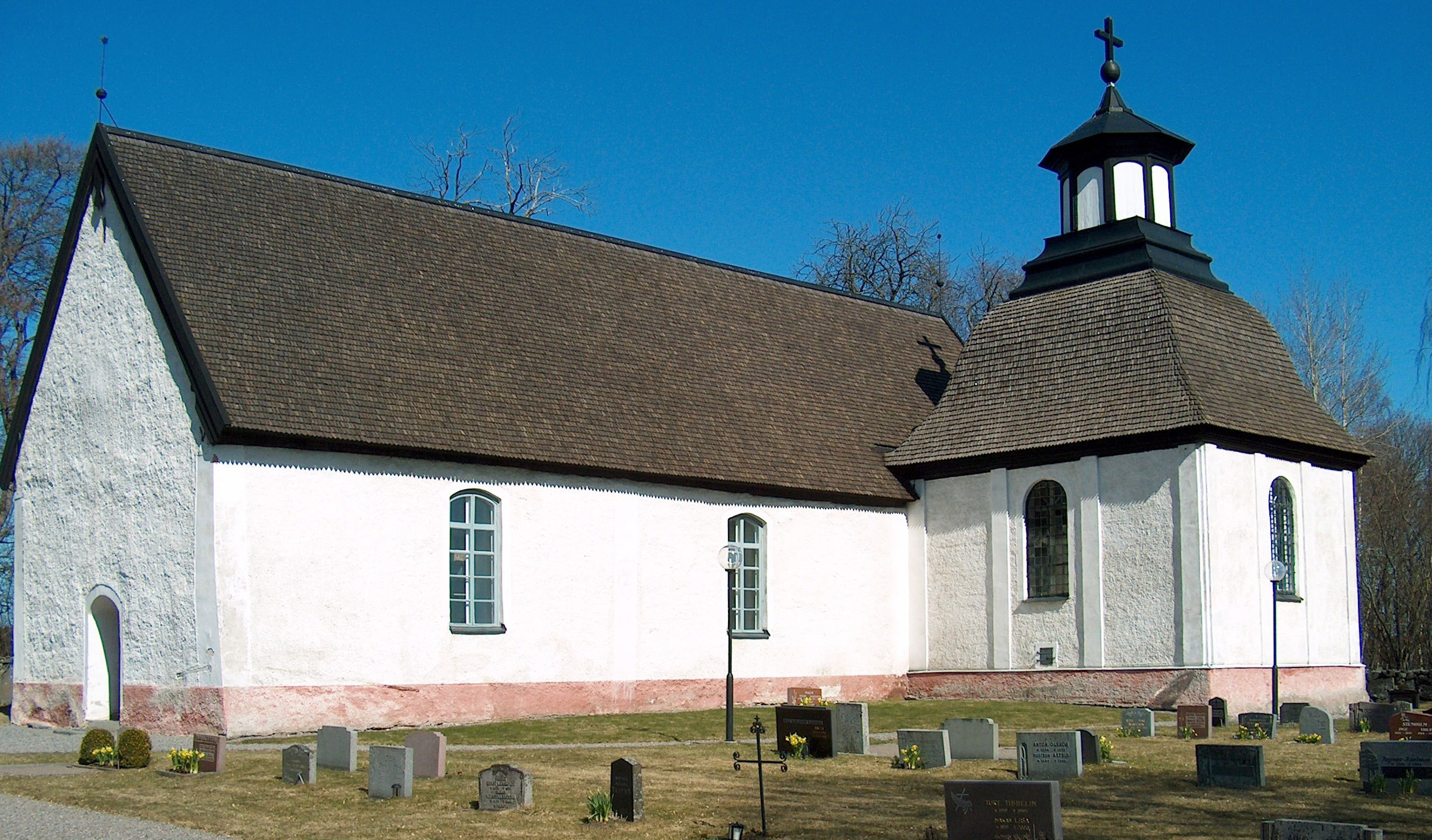 Vitkalkad kyrka i solljus