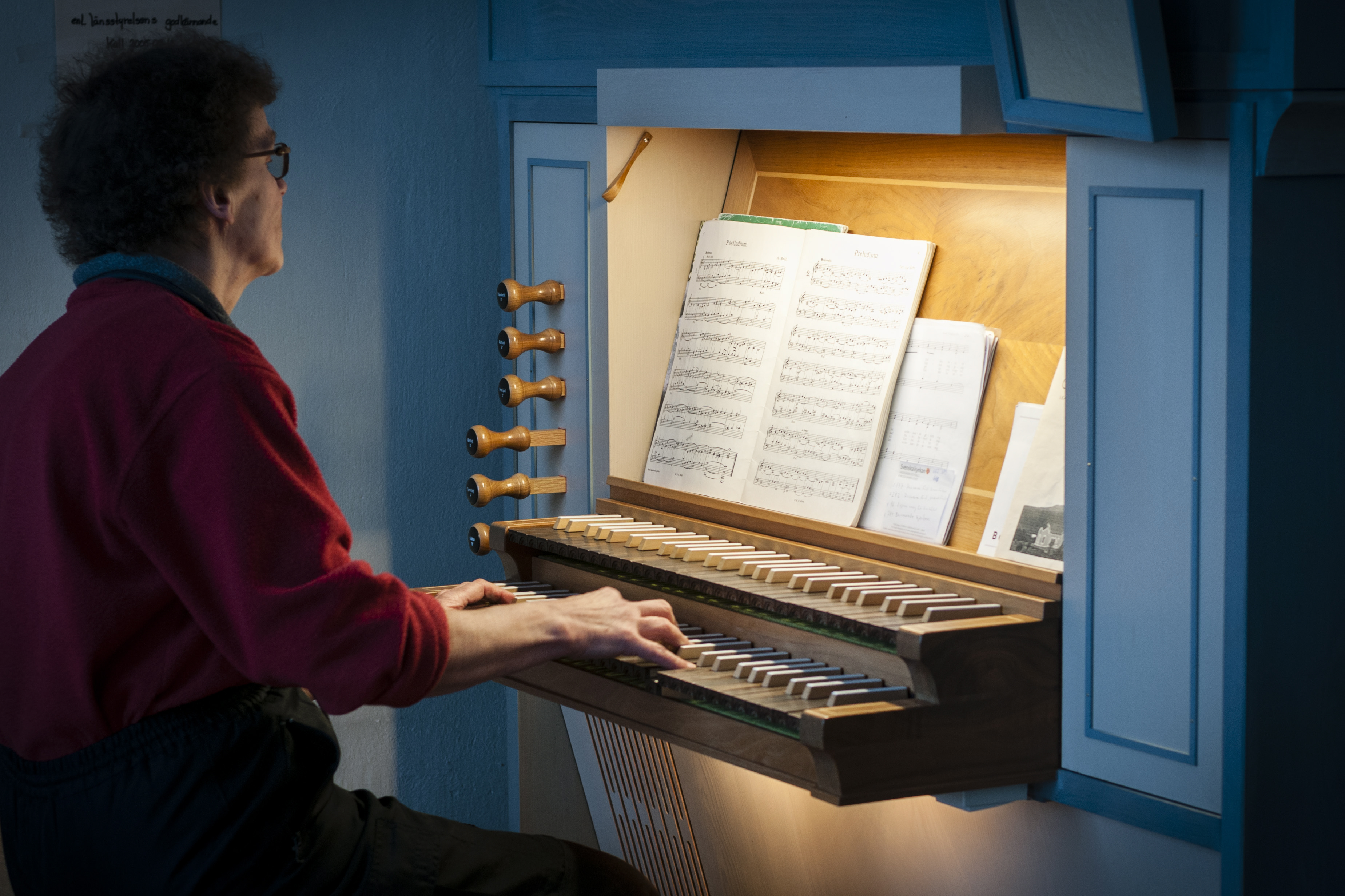 En kvinna spelar kyrkorgel.