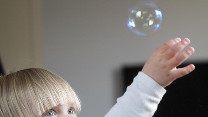 Ett barn leker med såpbubblor.