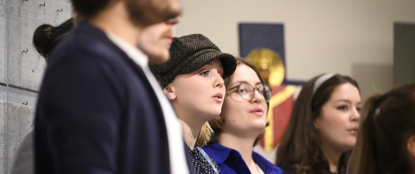 En blandad ungdomskör sjunger i en kyrka.