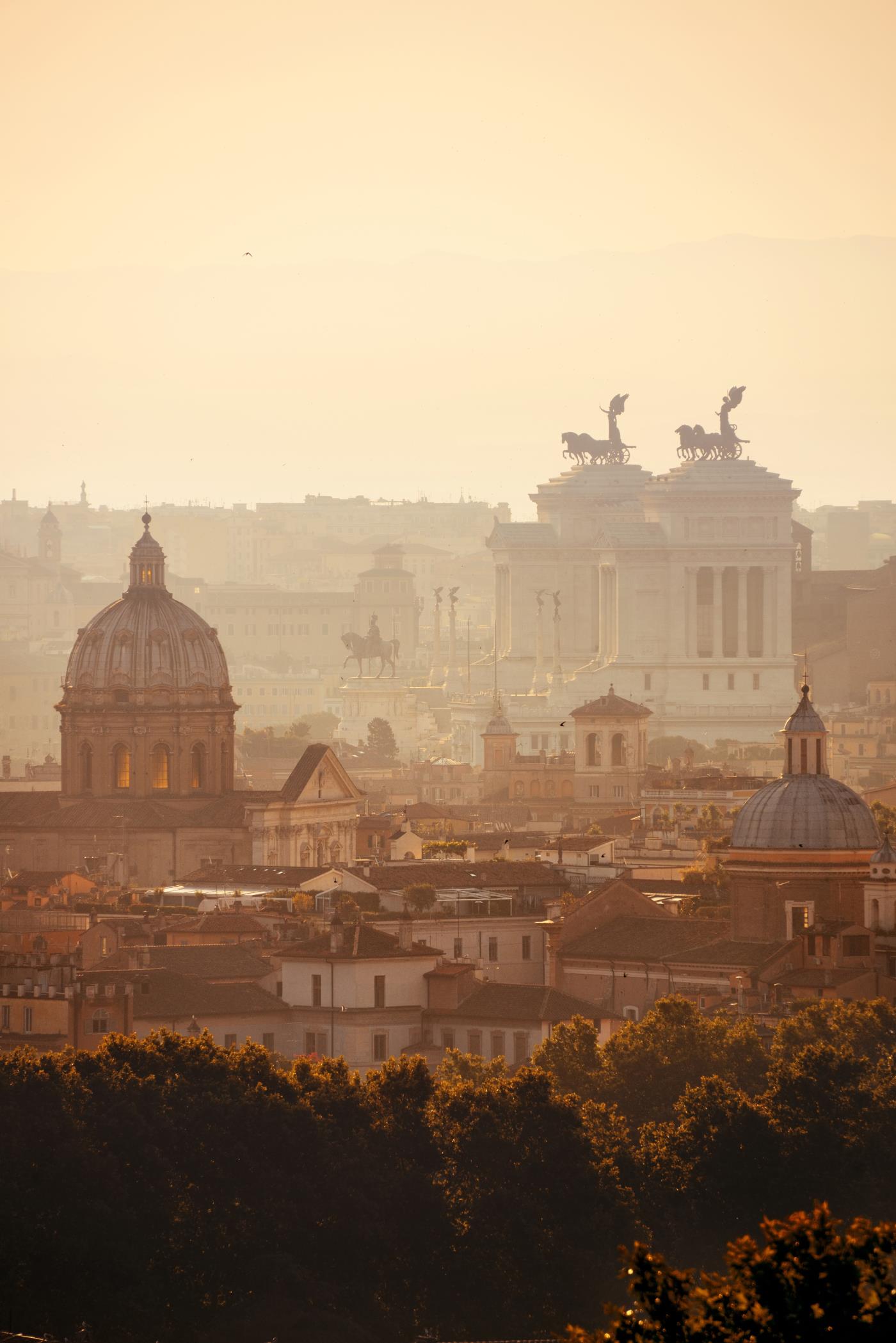 Rome rooftop view at sunrise silhouette with ancient architecture in Italy.